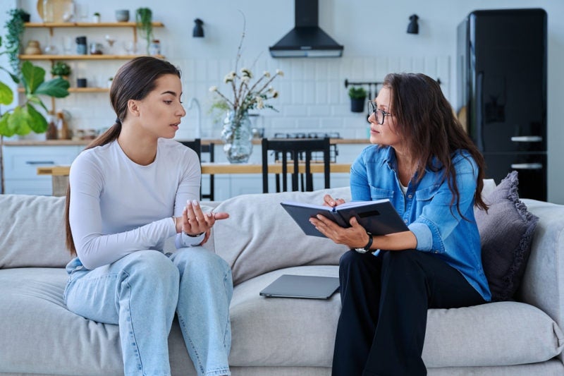 A young professional woman providing counseling to a client.