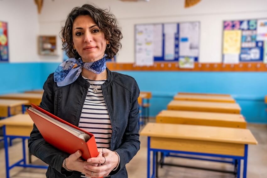 EdD Graduate standing in a classroom