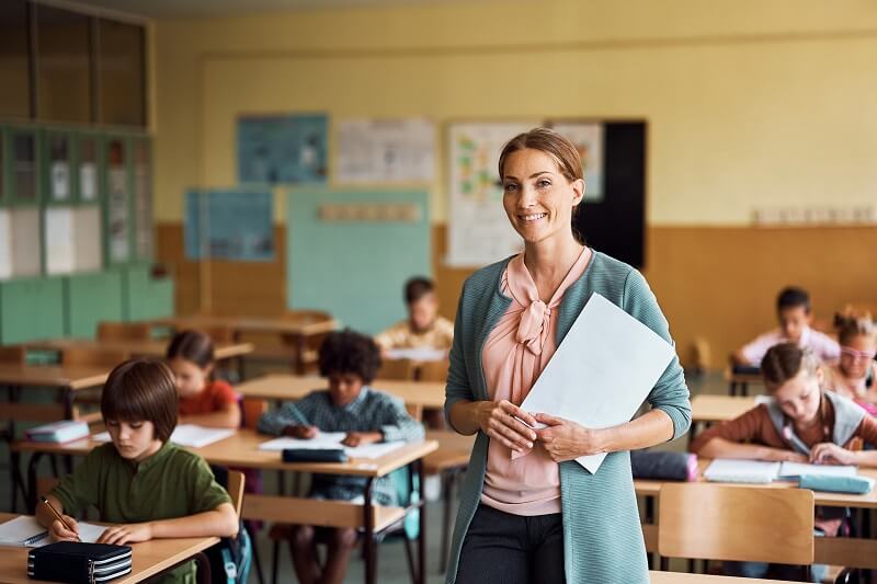 Female teacher standing in front of a classroom