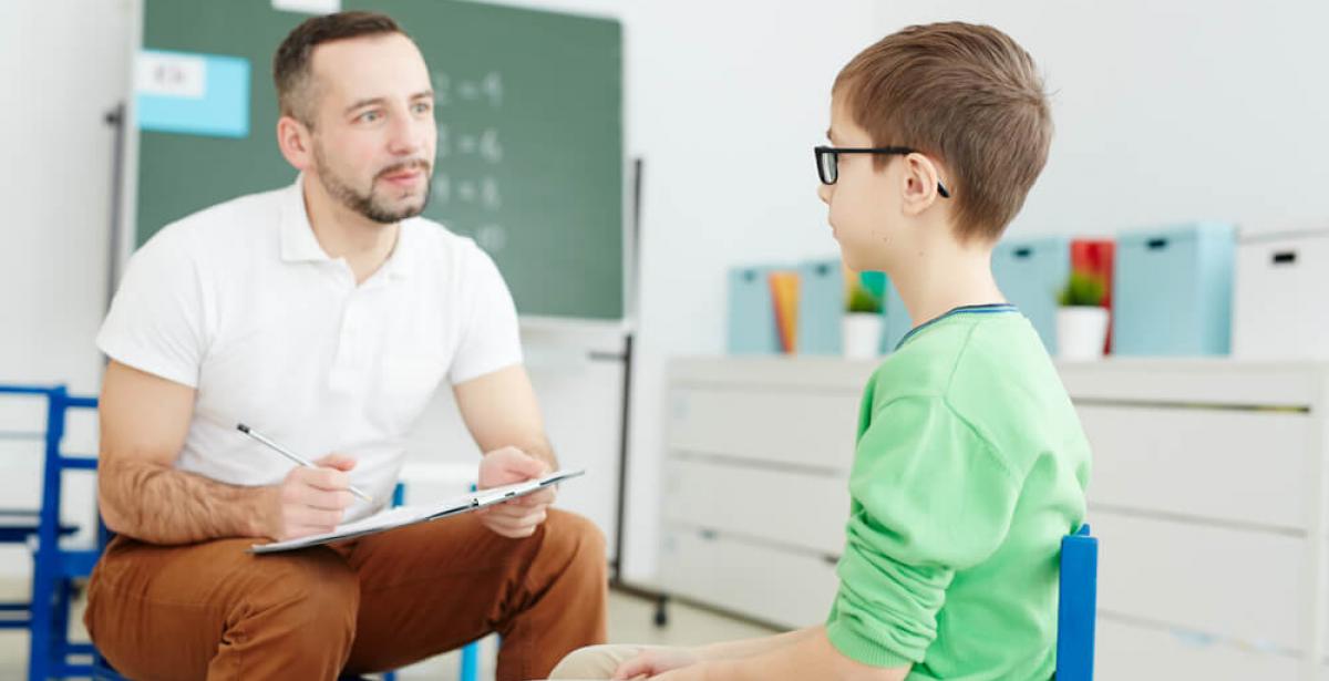 teacher counseling young boy