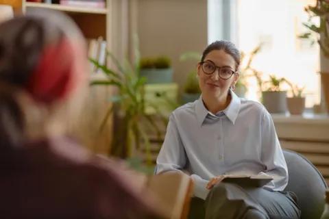 A licensed clinical mental health counselor in a session with a young client.